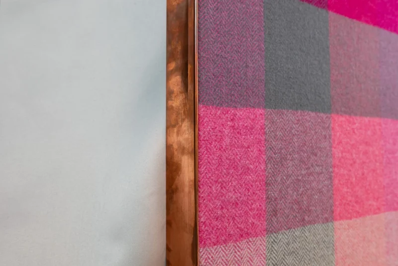 Pink fabric acoustic wall panel with squares design