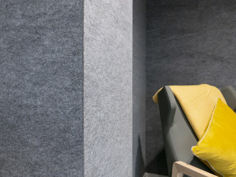 Felt grey acoustic wall panel installed in a seating pod